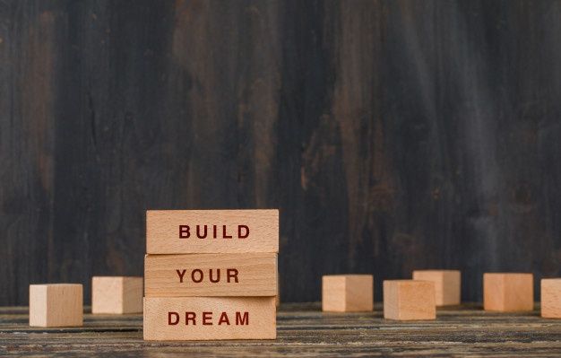 Business and motivation concept with wooden blocks on wooden table side view_ _ Free Photo